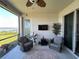 Screened patio featuring comfortable seating, a ceiling fan, and a view of the water at 169 Summershore Dr, Auburndale, FL 33823