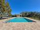 Community pool surrounded by trees and nature, offering relaxation and recreation at 169 Summershore Dr, Auburndale, FL 33823