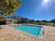 Relaxing community pool with brick paved deck, clear blue water and clear skies at 169 Summershore Dr, Auburndale, FL 33823