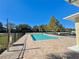 Community pool area showcasing the inviting pool, surrounding deck, and meticulously maintained fence at 169 Summershore Dr, Auburndale, FL 33823