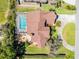 Aerial view of the backyard and pool, plus a bonus fire pit with outdoor seating at 2 Bridgewater Dr, Winter Haven, FL 33884