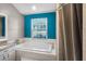 Bathroom showcases a large soaking tub next to a window and a walk in shower at 2 Bridgewater Dr, Winter Haven, FL 33884