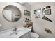 Charming bathroom with decorative mirror and wall art at 2 Bridgewater Dr, Winter Haven, FL 33884