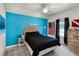 Stylish bedroom with a blue accent wall, window with curtains, and comfortable bed at 2 Bridgewater Dr, Winter Haven, FL 33884