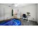 Bright bedroom with desk area, surfboard decor, and doorway at 2 Bridgewater Dr, Winter Haven, FL 33884