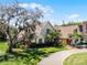 Charming two-story home with mature landscaping, a lush lawn, and a long driveway at 2 Bridgewater Dr, Winter Haven, FL 33884