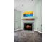 Inviting fireplace with light blue tile surround, wooden mantle, and beach-themed art at 2 Bridgewater Dr, Winter Haven, FL 33884