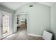 Hallway leading to bedroom with television, with light paint and carpeted flooring at 2 Bridgewater Dr, Winter Haven, FL 33884