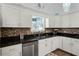 A kitchen featuring granite countertops, stainless steel appliances, and mosaic tile backsplash at 2 Bridgewater Dr, Winter Haven, FL 33884