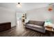 Cozy living room with wood-look flooring, gray sofa and warm lighting at 2 Bridgewater Dr, Winter Haven, FL 33884