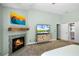 Inviting bedroom featuring a cozy fireplace, carpet and light paint at 2 Bridgewater Dr, Winter Haven, FL 33884