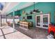 An outdoor patio with a bar, TV, ceiling fans, and access to the screened-in pool at 2 Bridgewater Dr, Winter Haven, FL 33884