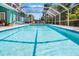Screened-in pool featuring ample deck space for entertaining with a clear blue sky overhead at 2 Bridgewater Dr, Winter Haven, FL 33884