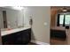Bathroom with double sinks, vanity, and access to bedroom at 214 Brook Ln, Polk City, FL 33868