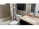 This full bathroom features a vanity, framed mirror, shower with floral curtain, and toilet at 214 Brook Ln, Polk City, FL 33868