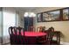 Elegant dining room featuring a large table with seating for eight, chandelier, and tasteful wall decor at 214 Brook Ln, Polk City, FL 33868