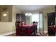 Formal dining room with a large dark wood table, seating for six, and a classic chandelier for intimate gatherings at 214 Brook Ln, Polk City, FL 33868