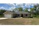 Charming single-story home featuring a two-car garage, well-maintained lawn, and delightful landscaping at 214 Brook Ln, Polk City, FL 33868