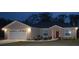 Charming single-story home featuring a two-car garage, inviting entrance, and landscaped front yard at 214 Brook Ln, Polk City, FL 33868