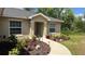 Inviting home entrance with a curved walkway, manicured landscaping, and a welcoming front door at 214 Brook Ln, Polk City, FL 33868