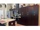 Modern kitchen showcasing stainless steel appliances, granite countertops, and ample dark wood cabinet space at 214 Brook Ln, Polk City, FL 33868