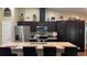 Spacious kitchen featuring granite countertops, stainless steel appliances, and dark wood cabinets at 214 Brook Ln, Polk City, FL 33868