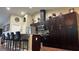 Contemporary kitchen featuring stainless steel appliances, a breakfast bar, and sleek, dark cabinetry at 214 Brook Ln, Polk City, FL 33868