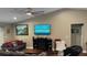 Comfortable living room featuring a fireplace, mounted television, and neutral color palette at 214 Brook Ln, Polk City, FL 33868