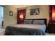 A view of the main bedroom with a large bed, neutral walls, dark wood furniture, and red curtains at 214 Brook Ln, Polk City, FL 33868