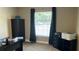 This home office features a large window for plenty of natural light, dark wood furniture, and neutral walls at 214 Brook Ln, Polk City, FL 33868