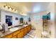 Spacious bathroom features a double sink vanity with granite countertop and decorative glass block window at 217 Kent Ct, Haines City, FL 33844