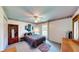 Inviting bedroom with a large window providing ample natural light and a ceiling fan for comfort at 217 Kent Ct, Haines City, FL 33844