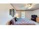Bedroom featuring a cozy bed, ceiling fan, and a view of the backyard at 217 Kent Ct, Haines City, FL 33844