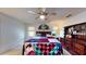 Bedroom featuring a colorful quilt, fan and wooden dresser at 217 Kent Ct, Haines City, FL 33844