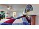 Bedroom featuring a colorful quilt, fan and access to other rooms at 217 Kent Ct, Haines City, FL 33844