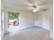 A bright bedroom featuring large windows, a closet, and light blue carpet at 217 Kent Ct, Haines City, FL 33844