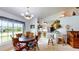 Cozy dining area with large window, seamlessly connecting to an open kitchen and living space at 217 Kent Ct, Haines City, FL 33844