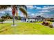 Landscaped front yard with a long driveway leading to a three-car garage at 217 Kent Ct, Haines City, FL 33844