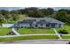 Inviting single-story home showcases solar panels, manicured lawn, and charming landscaping at 217 Kent Ct, Haines City, FL 33844