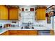 A well-lit kitchen showcasing a stainless sink, granite countertops, and wooden cabinetry at 217 Kent Ct, Haines City, FL 33844