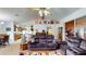 Comfortable living room featuring plush sofas, ceiling fan, and views into the adjacent kitchen and dining area at 217 Kent Ct, Haines City, FL 33844