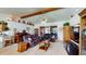 Bright living room with vaulted ceiling and decorative beams, seamlessly flowing into other living spaces at 217 Kent Ct, Haines City, FL 33844