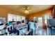 Home office with glass sliders, ceiling fan, multiple computer setups, and plenty of natural light at 217 Kent Ct, Haines City, FL 33844