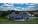 Spacious home featuring a covered patio, lush lawn, and a charming white picket fence at 217 Kent Ct, Haines City, FL 33844