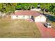 Aerial view of a beautiful single-story home with a well-manicured lawn and two-car garage at 218 Omaha St S S St, Lake Hamilton, FL 33851