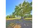 The backyard has an expansive green lawn, a large tree for shade, and views of a beautiful lake at 218 Omaha St S S St, Lake Hamilton, FL 33851