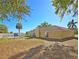 Expansive backyard with lawn, mature trees, and a play structure at 218 Omaha St S S St, Lake Hamilton, FL 33851