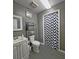 Traditional bathroom with white vanity, toilet, and patterned shower curtain at 218 Omaha St S S St, Lake Hamilton, FL 33851