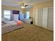 Bright bedroom featuring two beds, a ceiling fan, and ample closet space at 218 Omaha St S S St, Lake Hamilton, FL 33851