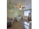 Bright bedroom featuring green walls, wood floors and a ceiling fan at 218 Omaha St S S St, Lake Hamilton, FL 33851